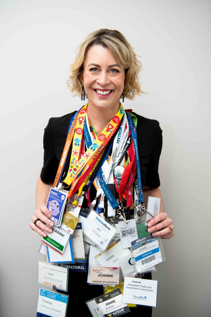 Joey with dozens of trade show lanyards hanging around her neck