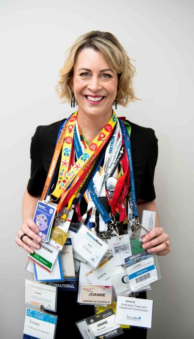 Joey with dozens of trade show lanyards hanging around her neck